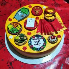 a cake decorated with different types of jewelry on top of a red and yellow table cloth