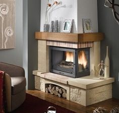 a living room filled with furniture and a fire place in the middle of the room