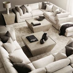 a living room filled with lots of white furniture