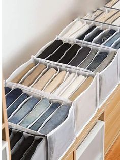 an organized drawer with several pairs of jeans in it and the bottom drawers are open