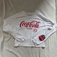 Never Worn In Great Condition “Always Coca-Cola” Pin Design On The Left Sleeve Trendy Red Long Sleeve T-shirt, Trendy Long Sleeve Red T-shirt, Trendy White Long Sleeve T-shirt, Casual Long Sleeve Red T-shirt, Casual Red Long Sleeve T-shirt, Casual White Letter Print Tops, Casual White Print Cotton Tops, Basic Red Top With Text Print, Casual Red Tops With Letter Print