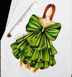 a drawing of a green dress with ruffles on it and a pencil next to it