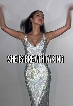 a woman in a silver dress with her arms up and the words she is breathtaking above her head