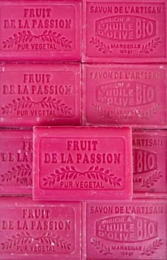 four bars of pink soap sitting on top of each other