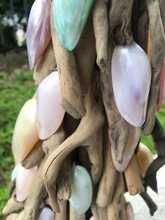 a bunch of different colored glass beads hanging from a tree