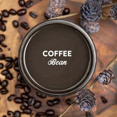 coffee bean in a tin surrounded by pine cones