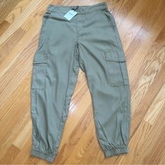 Oat Drapey Cargo Pants Joggers Pants Pull On Side Cargo Pockets Back Elastic Band Tan Size Small Nwt Qq Khaki Utility Pants With Elastic Waistband, Non-stretch Tapered Leg Cargo Pants With Side Pockets, Non-stretch Khaki Cargo Pants With Side Pockets, Trendy Khaki Ankle-length Cargo Pants, Stretch Cargo Style Tapered Leg Bottoms, Stretch Tapered Leg Cargo Bottoms, Stretch Khaki Cargo-style Bottoms, Stretch Khaki Cargo Pants With Side Pockets, Stretch Khaki Cargo Trousers