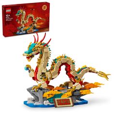 the lego dragon is on display with its box