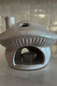 a white ceramic object on top of a counter