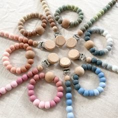 a bunch of beads that are laying on a tablecloth with one bead in the middle