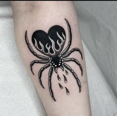 a spider with flames on it's legs is seen in this tattoo design by the artist