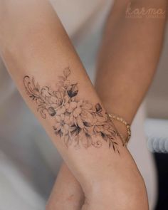 a woman's arm with flowers on it