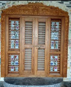 an ornate wooden door with glass panels on the front and side doors to both sides