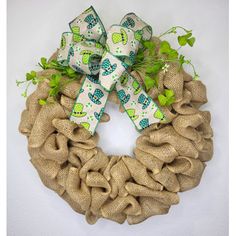 a burlock wreath with green leaves and bows