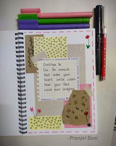 a notebook with some writing on it next to markers and pencils in the background