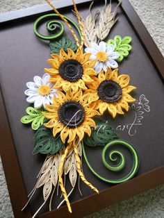 an artistically designed card with sunflowers and leaves on it's side