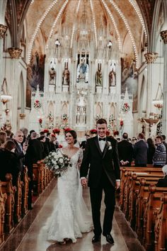 a bride and groom walk down the aisle at their wedding ceremony in an old church