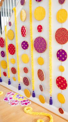 the wall is decorated with colorful circles and tassels, along with other decorations