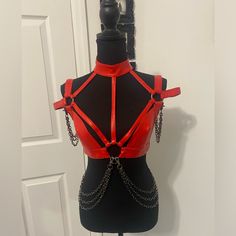 This Harness Top Has A Vegan Leather Construction, A Plunging Neckline With A Choker, O-Ring Hardware At The Shoulders And Bust, Layered Silver Chains Draped Along The Hips And Arms, And Adjustable Buckle Closures. Wooden Cheese Board, Silver Chains, Leather Harness, Cell Phone Holster, Phone Holster, Walker Boots, Fit N Flare Dress, Plunging Neckline, Dolls Kill