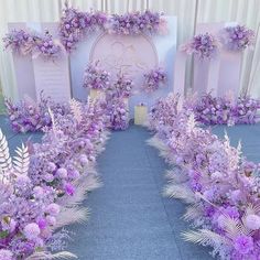 an outdoor ceremony with purple flowers and greenery