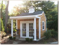 a small wooden building sitting in the middle of a forest