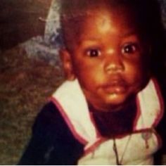 a young child is looking at the camera with an intense look on his face and shoulders