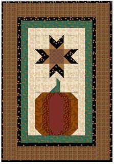 a quilted wall hanging with a pumpkin and star on it's center piece