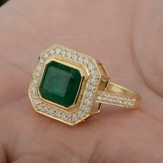 Genuine Square Emerald Ring/ 14K Solid Gold Statement Ring/ Emerald Diamond Halo Ring/ Emerald Engagement Ring/ Certified Handmade Ring ≫ Features * item code: SR01754 * Diamond: 100% Genuine Diamond * Diamond Wt: 0.66 Ct. * Diamond Color: G-H * Diamond Clarity: S2-SI1 * Diamonds Cut: Brilliant Cut (Excellent Cut) * Emerald Gemstone Wt.:- 4.75 Ct. * Metal: 14K Solid Gold (18K also available - Additional fees may apply) * More options in gold color: Rose gold, yellow gold, White gold * Ring Size: 14k Gold Gia Certified Emerald Ring Gift, Gia Certified Emerald Ring In 14k Gold For Anniversary, Anniversary Emerald Ring, Gia Certified, 14k Gold, Anniversary 14k Gold Emerald Ring Gia Certified, Gia Certified 14k Gold Emerald Ring Gift, Anniversary 14k Gold Gia Certified Emerald Ring, Gia Certified Yellow Gold Emerald Cut Halo Ring, Gia Certified Emerald Cut Yellow Gold Halo Ring, Gia Certified 14k Gold Cluster Ring