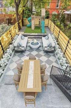 an outdoor living area with furniture and plants on the ground, in front of a fence