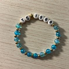 a blue beaded bracelet with white letters on it