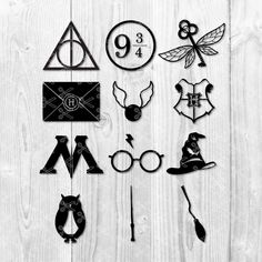 some harry potter symbols on a white wooden background