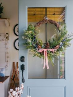 a wreath is hanging on the front door