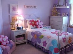 a child's bedroom with pink and purple decor