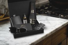 a kitchen counter top with an assortment of items on it and a stove in the background