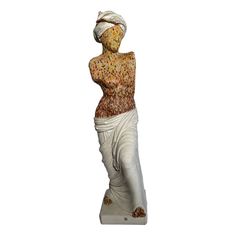 a white statue with a woman's head wrapped around her body and hands behind her back