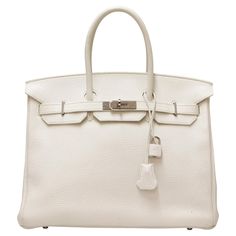 White Birkin with silver hardware, delivered in its original HERMES dustbag ! Condition: very good, it has been worn very little. Made in France Model : Birkin Size : 35 Material : grained leather - Taurillon Clémence Colour : white Dimensions : 35 x 28 x 18 cm Stamp Letter : R in a square - Year : 2014 Hardware : silver, palladium metal Details : padlock and keys (x2), clochette White Birkin, Stamp Letter, Palladium Metal, Hermes Birkin 35, Letter R, Hermes Birkin, Luxury Items, Silver Hardware, Fashion Handbags