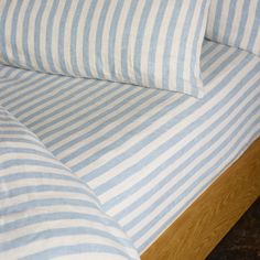 a bed with blue and white striped sheets