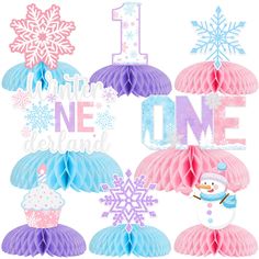 the first birthday decorations are pink, blue and white with snowflakes on them