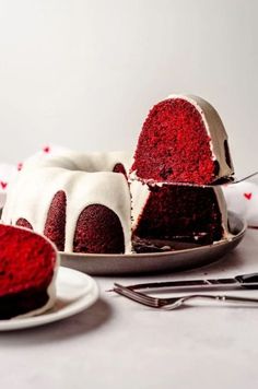 a red velvet bunt cake with white frosting on a plate next to it