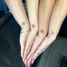 two girls with matching tattoos on their hands