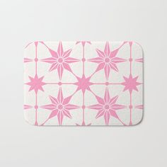 a pink and white bath mat with stars on it