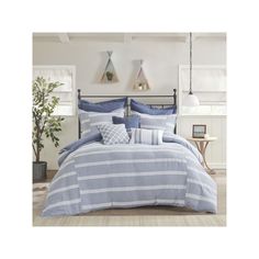 a bed with blue and white striped comforter in a living room next to a potted plant