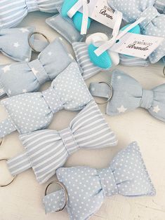 several blue and white bow ties are laying on the floor next to some other items