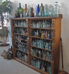 an old wooden cabinet filled with lots of bottles