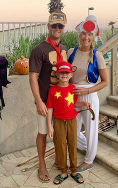 a man, woman and child dressed up in costumes