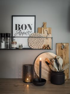 a wooden table topped with plates and candles