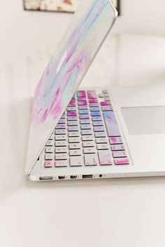 an open laptop computer sitting on top of a white desk