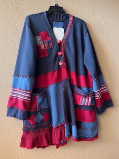 a blue and red jacket hanging on a wall