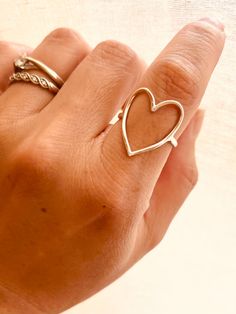 This Sterling Silver Hammered Heart Ring is perfect for any occasion - from casual everyday style to a romantic statement that feels as sweet as young love. PRODUCT DETAILS limited edition, Sizes: 7-10 This listing is for ONE (1) hammered open-heart ring. Material: Crafted from high-quality 925 Sterling Silver. ＊Please note that our rings are carefully handcrafted and hammered, which means that each finished product may have slight variations. Trendy Silver Heart Ring For Valentine's Day, Trendy Silver Heart Ring For Anniversary, Everyday Open Heart Rings With Heart Charm, Dainty Open Heart Ring For Valentine's Day, Simple Heart Midi Rings, Valentine's Day Gift Midi Rings With Open Heart, Valentine's Day Gift Open Heart Midi Rings, Valentine's Day Gift Midi Open Ring, Trendy Open Heart Ring For Valentine's Day