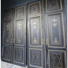 two black doors with gold designs on them